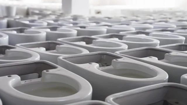 Rows of glossy white ceramic bodies in the factory
